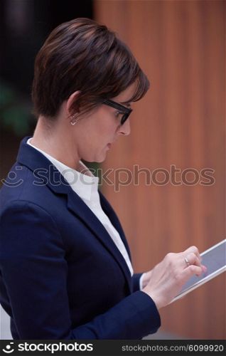 corporate business woman working on tablet computer at modern office interior