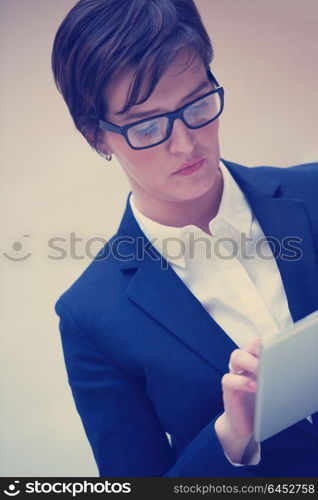 corporate business woman working on tablet computer at modern office interior