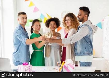 corporate, celebration and holidays concept - happy team clinking glasses of non-alcoholic sparkling wine at office birthday party. happy team with champagne at office birthday party