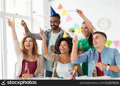 corporate, celebration and holidays concept - happy team with confetti and serpentine having fun at office birthday party. happy team with confetti at office birthday party