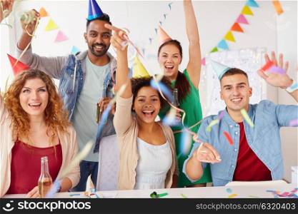 corporate, celebration and holidays concept - happy team with confetti and serpentine having fun at office party. happy team having fun at office party