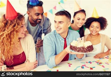 corporate party and people concept - happy team with cake and non-alcoholic drinks celebrating colleague 21st birthday at office. team greeting colleague at office birthday party