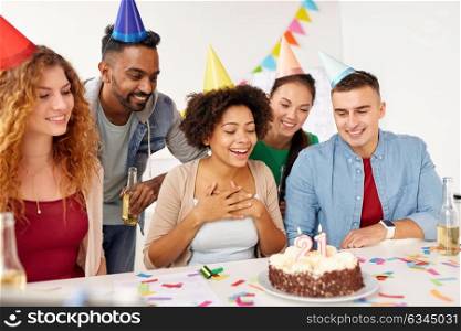 corporate party and people concept - happy team with cake celebrating colleague 21st birthday at office. team greeting colleague at office birthday party