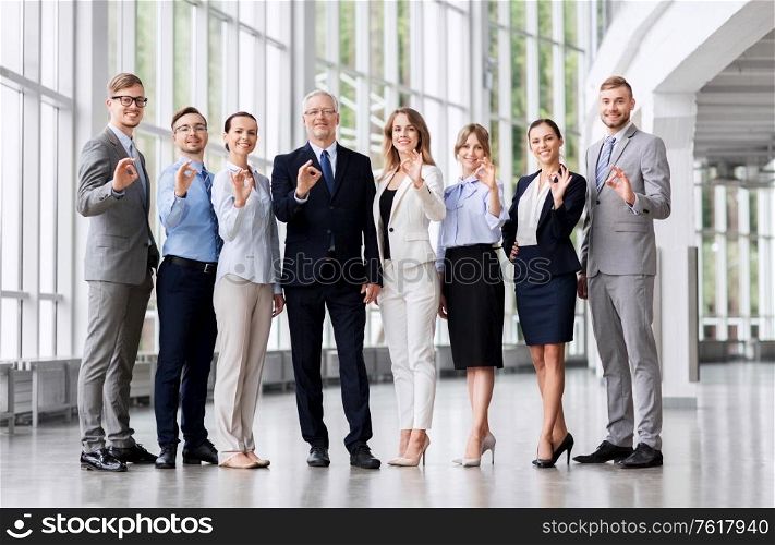 corporate, people and teamwork concept - business team showing ok hand sign at office. business people showing ok hand sign at office