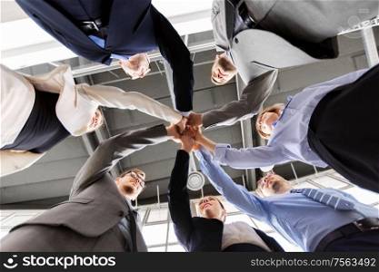 corporate, success and teamwork concept - happy business team making high five at office from below. business people making high five at office