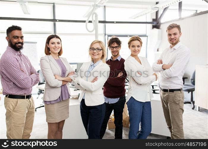 corporate, teamwork and peope concept - happy business team in office