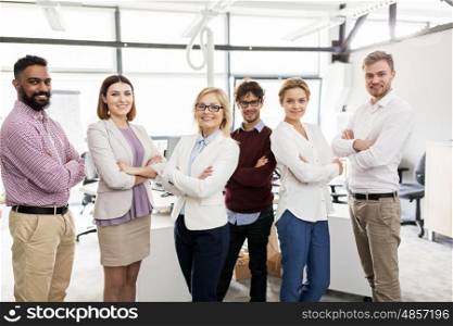 corporate, teamwork and peope concept - happy business team in office