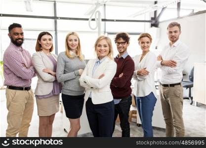 corporate, teamwork and people concept - happy business team in office