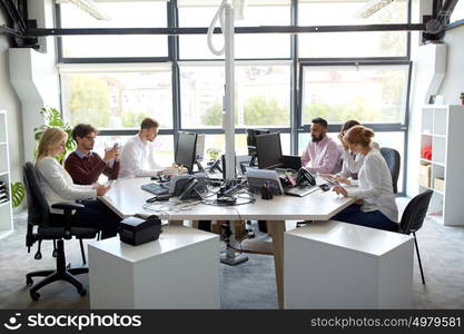 corporate, technology and people concept - business team with smartphones and computers working at office. business team with computers working at office