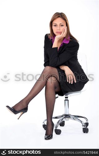 Corporate woman on a chair.