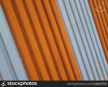 corrugated metal fence painted in orange and silver