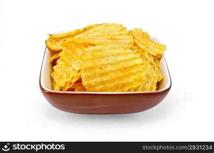 Corrugated potato chips in a clay bowl isolated on white background