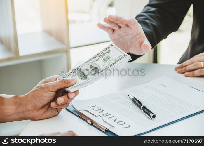 Corruption concept,Businessman manager refusing receive money from Business man passing money dollar bills corruption bribery