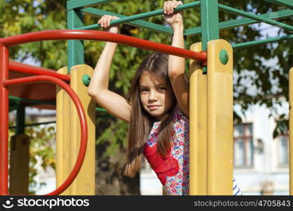 Cose up, Beautiful little girl on green background of summer city park