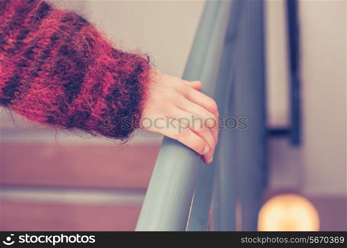 Coseup on woman&rsquo;s hand holding onto a banister