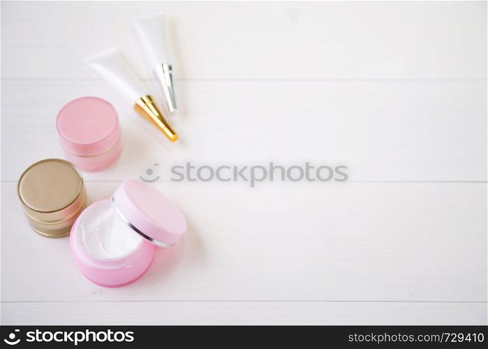 cosmetic and skin care product on white wood table, beauty with treatment cream and moisturizer on wooden desk, health and wellness concept, top view.