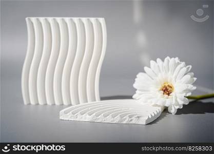 Cosmetic background for product presentation. White empty plaster podium with shadows on gray background. Background for product presentation.