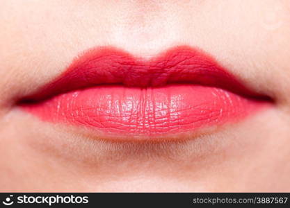 Cosmetic beauty procedures and makeover concept. Closeup part of woman face red lips makeup detail. Lipstick or lipgloss