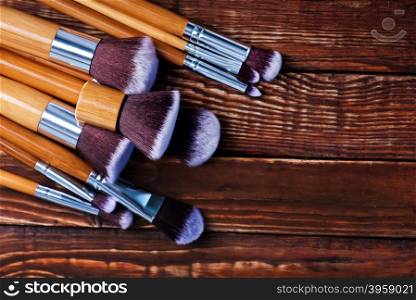 cosmetic brushes on the wooden table, clear brushes