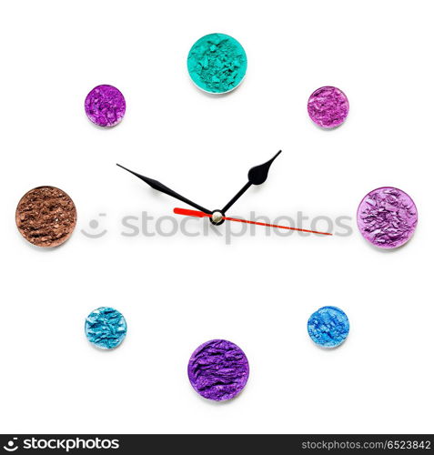 Cosmetic clock.. Creative concept photo of cosmetics swatches in the shape of clock on white background.