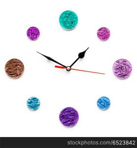 Cosmetic clock.. Creative concept photo of cosmetics swatches in the shape of clock on white background.