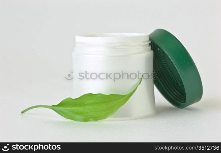cosmetic cream and green leaf