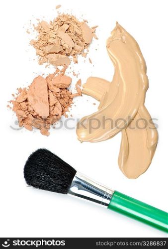 Cosmetic foundation cream and powder with brush on white background