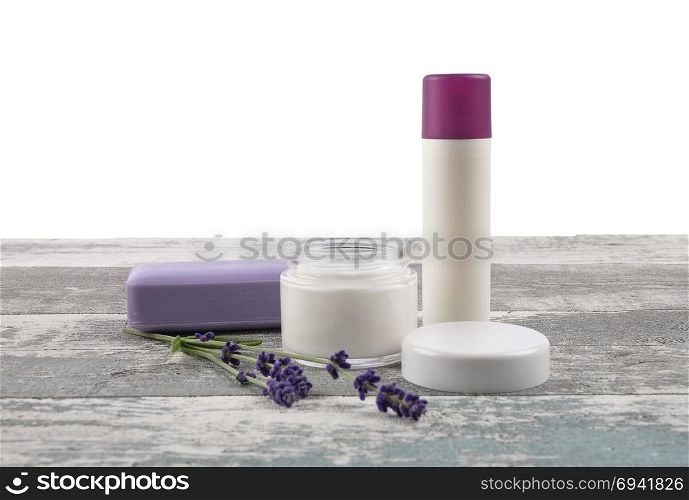 Cosmetic products and lavender on weathered wood