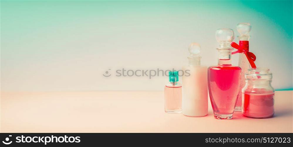Cosmetic products banner. Different cosmetic bottles collection on Beautiful pink turquoise blue background, front view. Cosmetic shop, Beauty, skin and hair care or spa treatment concept