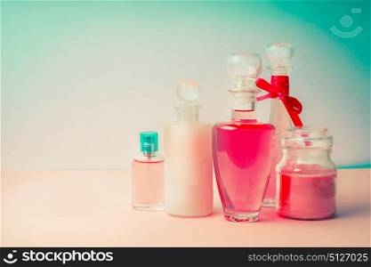 Cosmetic products collection with various bottles : tonic,lotion, perfume, Moisturizer, cream, soups, foams, shampoo on Beautiful pink turquoise blue background, front view. Cosmetic shop concept