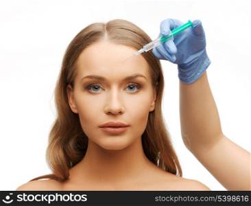 cosmetic surgery concept - woman face and beautician hand with syringe