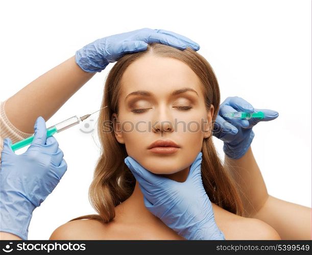 cosmetic surgery concept - woman face and beautician hands with syringes