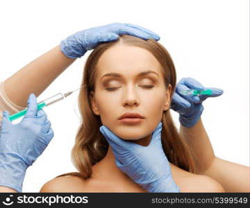 cosmetic surgery concept - woman face and beautician hands with syringes
