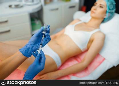 Cosmetician makes botox therapy to female patient on treatment table. Rejuvenation procedure in beautician salon. Doctor and woman, cosmetic surgery against wrinkles and aging