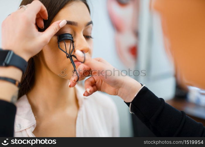 Cosmetician works with woman&rsquo;s eyelashes in cosmetics store. Luxury beauty shop salon, female customer and beautician in fashion market. Cosmetician works with woman&rsquo;s eyelashes in store