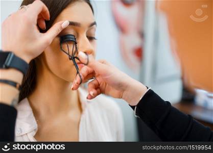 Cosmetician works with woman&rsquo;s eyelashes in cosmetics store. Luxury beauty shop salon, female customer and beautician in fashion market. Cosmetician works with woman&rsquo;s eyelashes in store