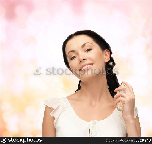 cosmetics and beauty concept - beautiful woman spraying pefrume on her neck