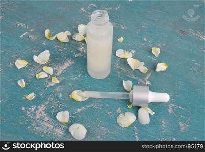 Cosmetics and rose petals on weathered concrete