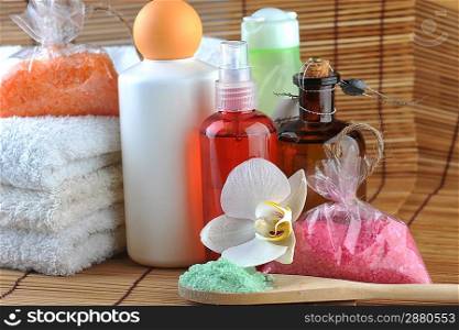Cosmetics for body, orchid and towel on straw napkin