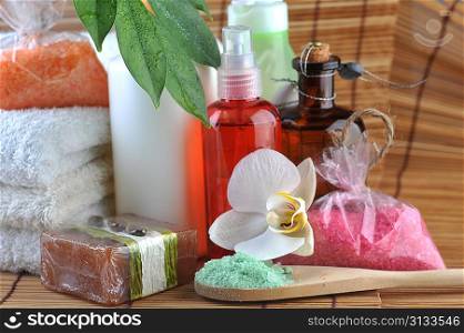 Cosmetics for body, orchid and towel on straw napkin
