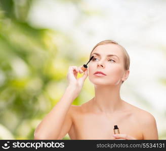 cosmetics, health and beauty concept - beautiful woman with mascara