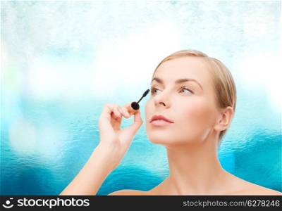 cosmetics, health and beauty concept - beautiful woman with mascara
