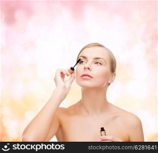 cosmetics, health and beauty concept - beautiful woman with mascara