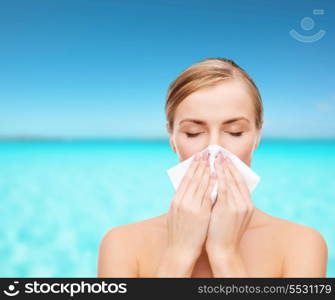 cosmetics, health and beauty concept - beautiful woman with paper tissue and closed eyes