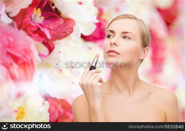 cosmetics, health and beauty concept - beautiful woman with pink lipstick