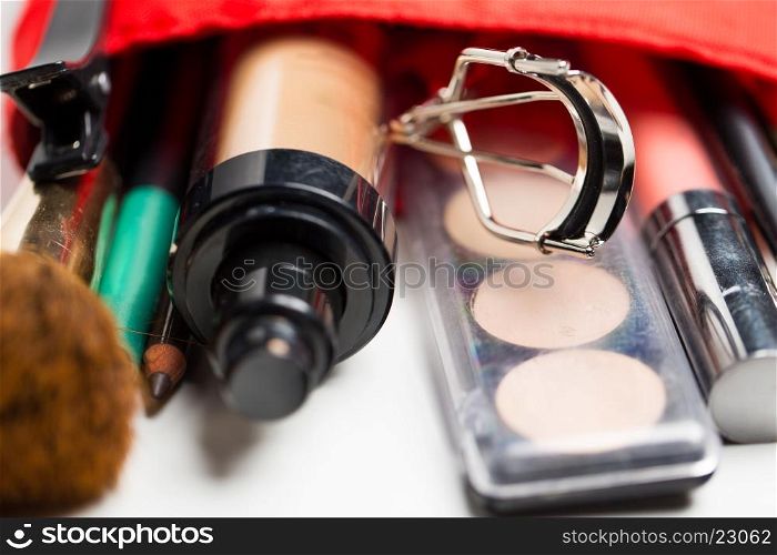 cosmetics, makeup and beauty concept - close up of cosmetic bag with makeup stuff