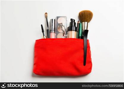cosmetics, makeup and beauty concept - close up of cosmetic bag with makeup stuff
