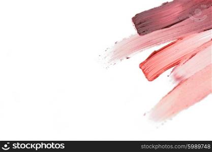 cosmetics, makeup and beauty concept - close up of lipstick smear sample