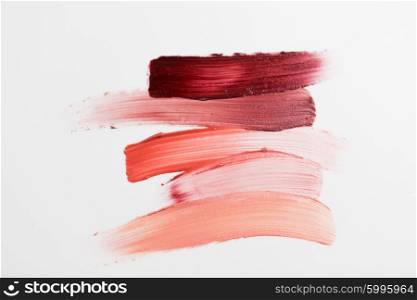 cosmetics, makeup and beauty concept - close up of lipstick smear sample