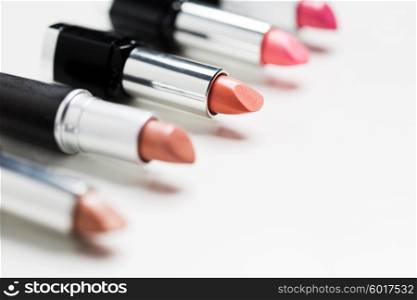 cosmetics, makeup and beauty concept - close up of lipsticks range